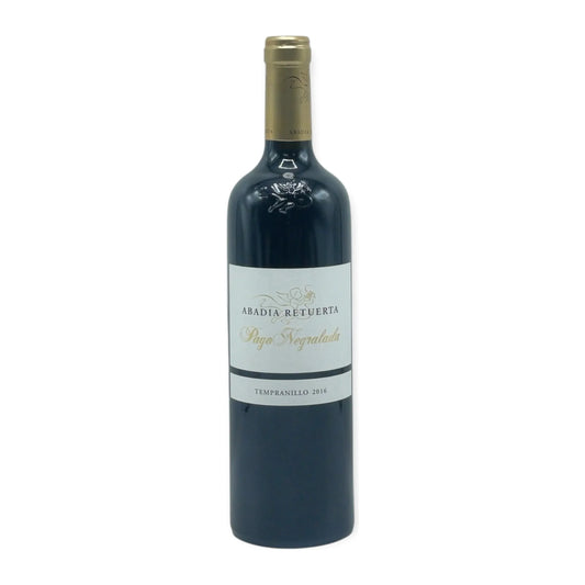 Bottle of Abadía Retuerta Pago Negralada 2016 – single-vineyard Tempranillo from Castilla y León, Spain, resting on gravel and stone with notes of black cherry and cedar.