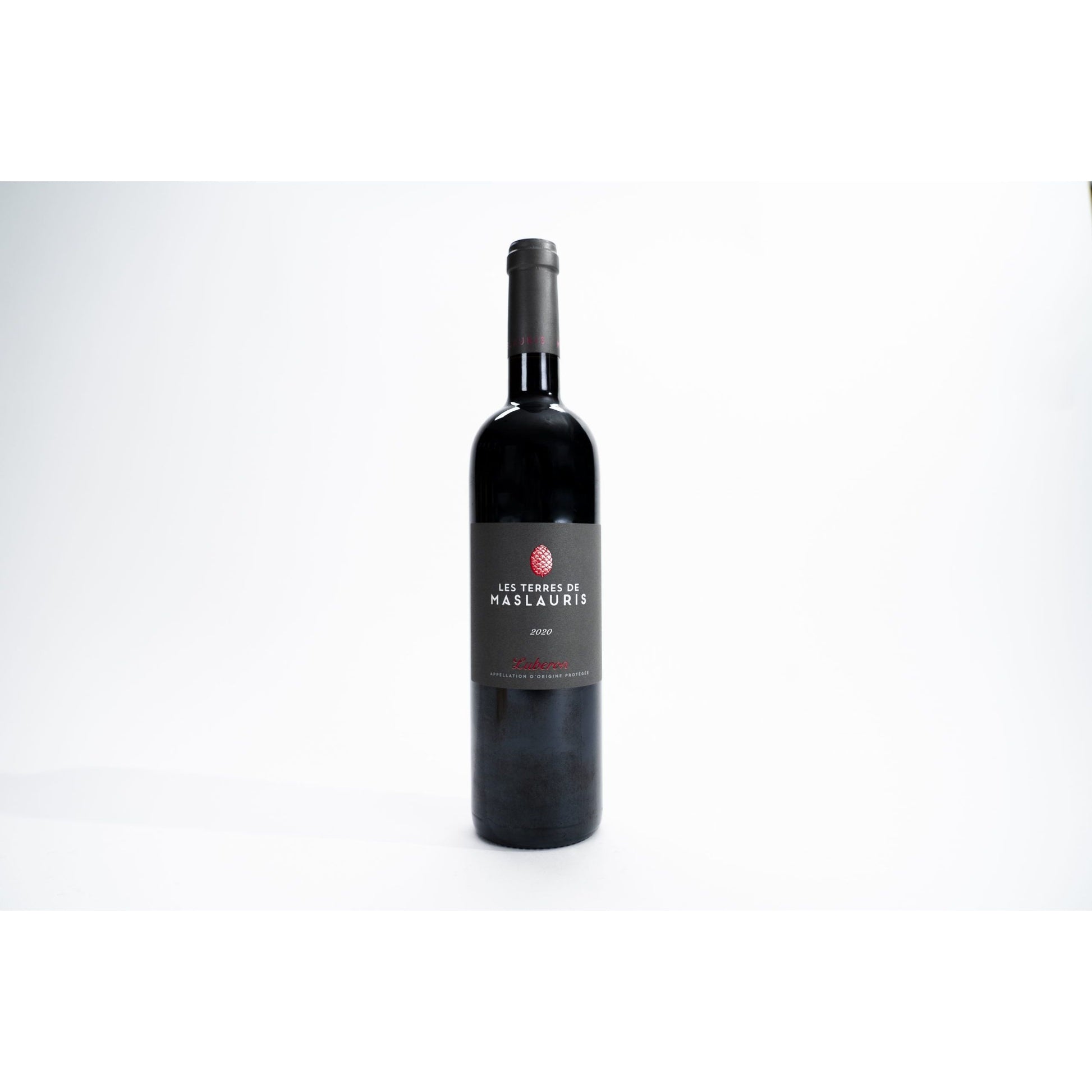 Bottle of Les Terres de MasLauris 2022 – an organic GSM blend from Luberon, France, with ruby red color, wild herb accents, and limestone soil backdrop.