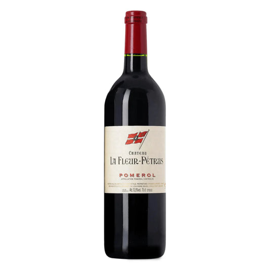 Bottle of Château La Fleur-Pétrus 2016 – Bordeaux red blend with garnet color, aromas of truffle and blackberry, firm tannins, and a long, elegant finish from Pomerol.