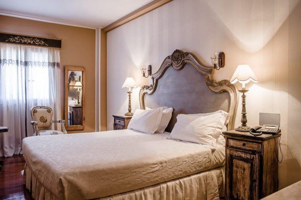 “Rustic-chic guest room with antique bedframe at Don Fadrique