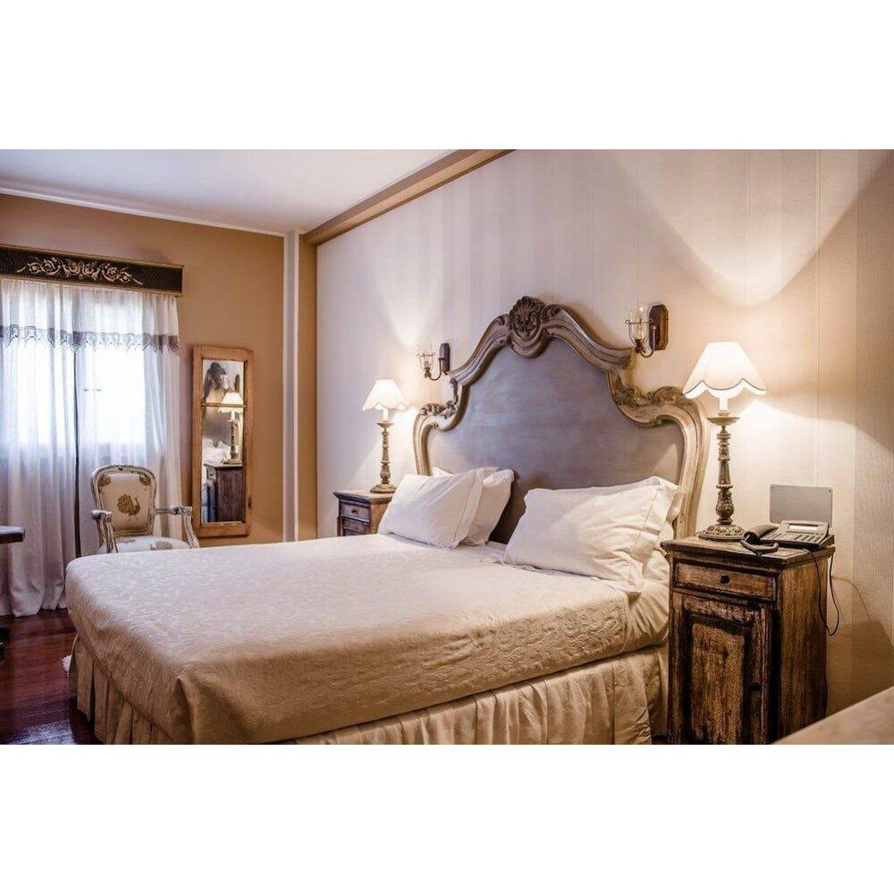 “Rustic-chic guest room with antique bedframe at Don Fadrique