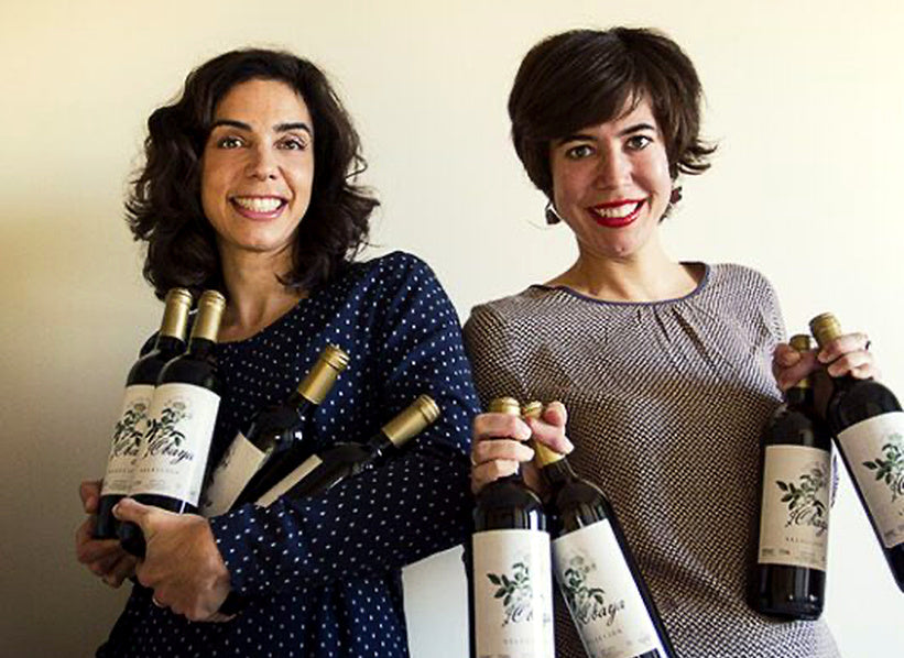 Two women holding wine bottles, photograph supplied for De Andrés Sisters