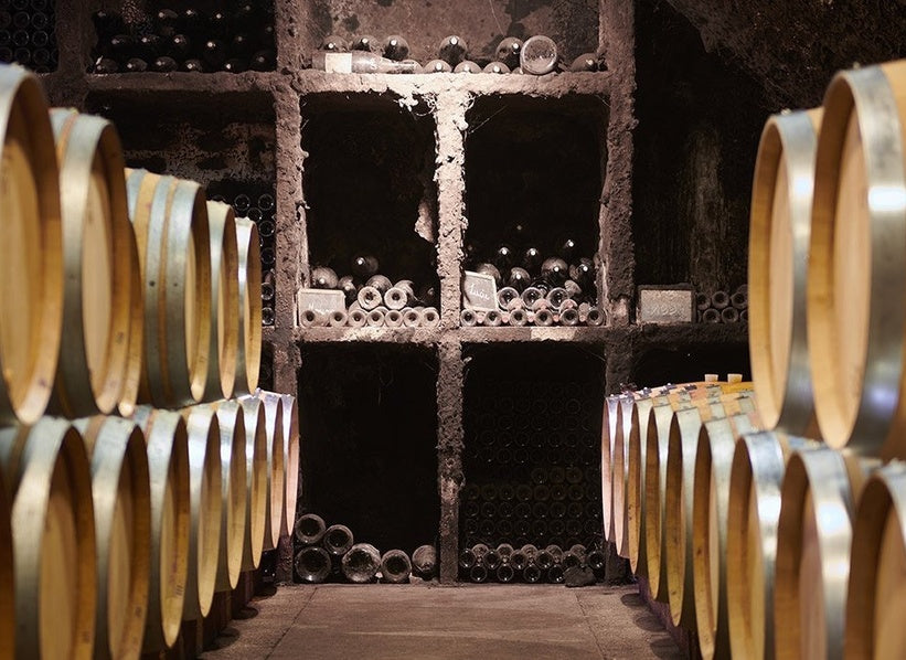 Historic Burgundy wine cellar with barrels and bottle storage