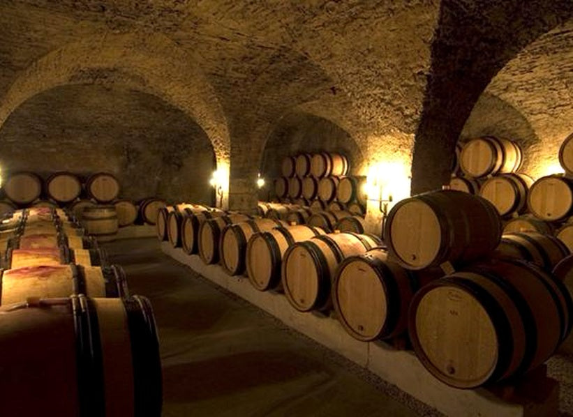 Stone-vaulted Burgundy cellar with oak barrels, Maison Roche de Bellene