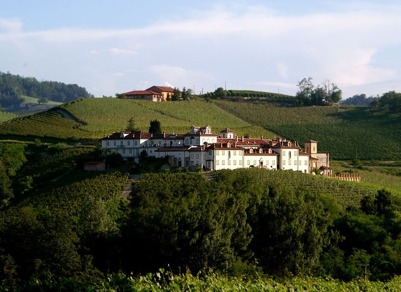 Historic estate buildings among vineyard-covered hills in Piedmont, featured for Poderi Aldo Conterno