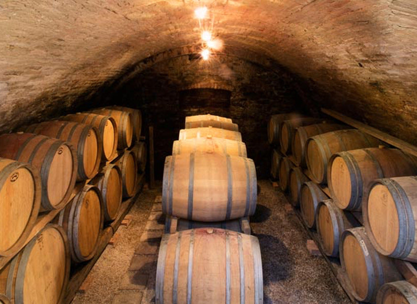 Oak barrels inside a vaulted wine cellar, photo supplied for Vietto